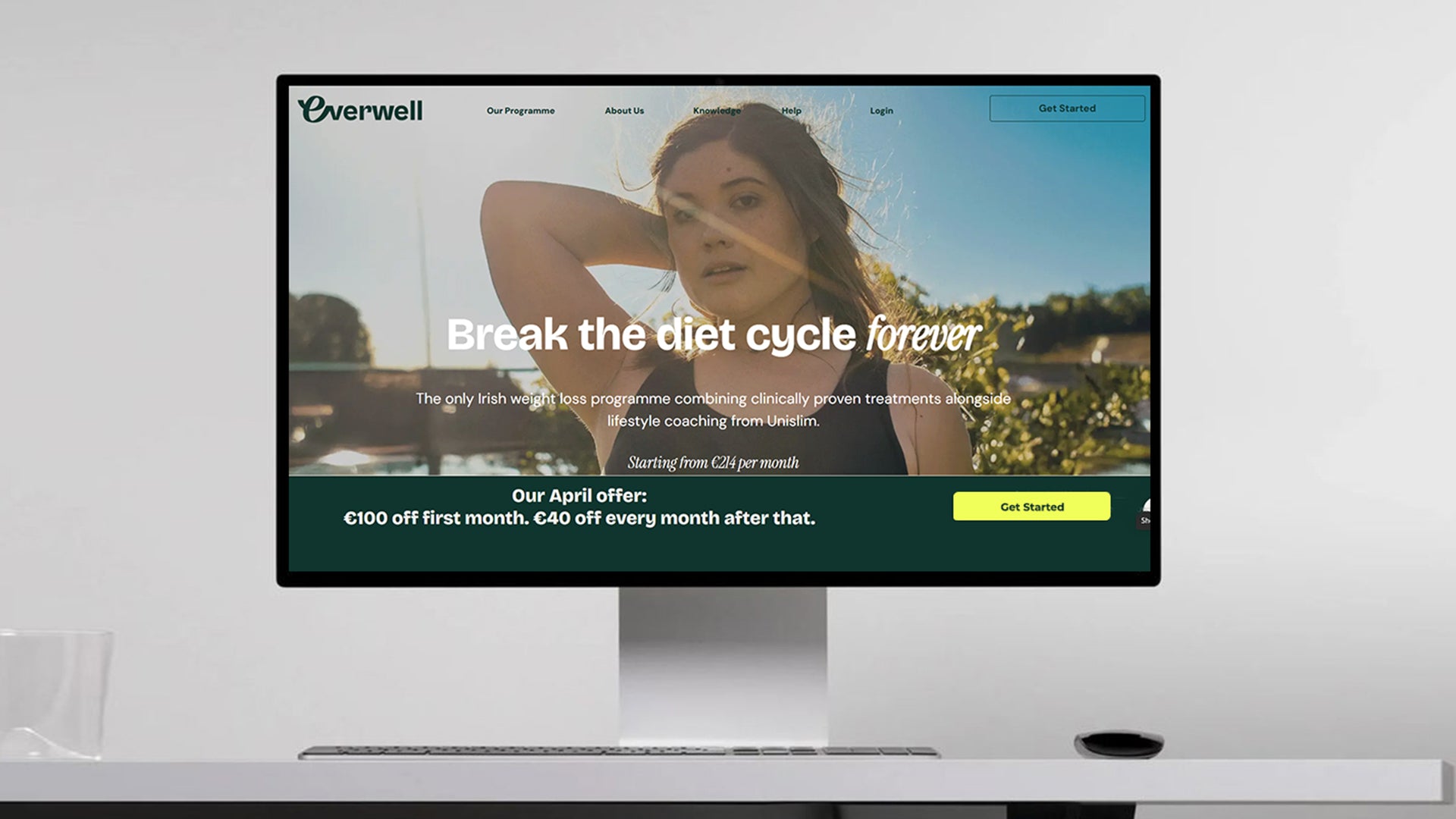 Computer monitor displaying a Everwell diet program advertisement with a woman in the background.