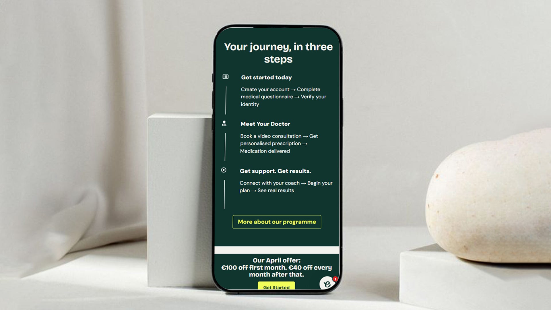 Smartphone displaying a health and wellness Shopify store on a white surface with a light gray background