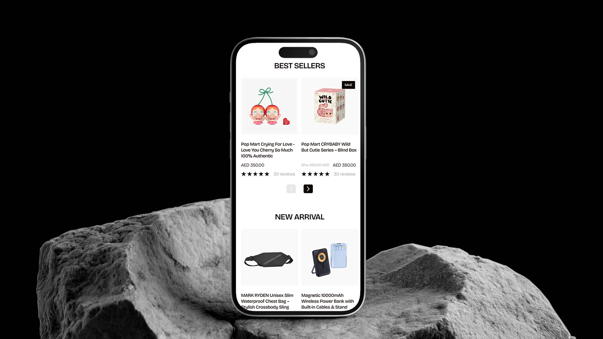 Smartphone displaying NARA Space e-commerce app on a rocky surface with a black background